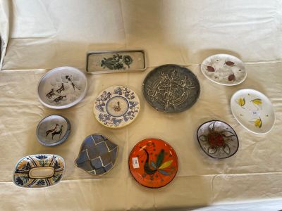 a lot of plates and bowls on the table