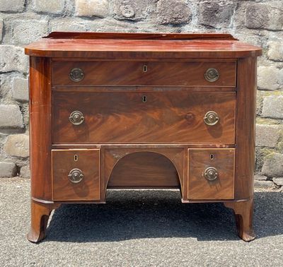 a small chest of drawers sitting on the pavement