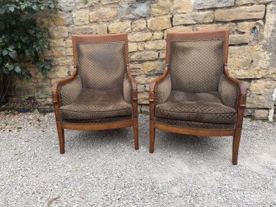 pair of vintage upholstered armchairs with upholstered cushions