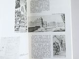 an open book with a drawing of a castle in it