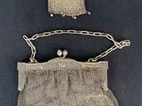 two silver mesh purses with pearls hanging from them