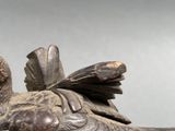 a statue of a bird that is sitting on top of a table