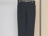 a close up of a black pants hanging on a clothes rack