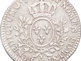a silver coin with a crown on top of it