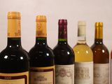several bottles of wine are lined up on a table