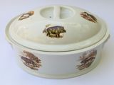a white casserole with animals on it on a white table