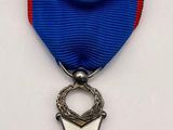 a close up of a medal with a cross on it