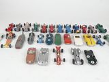 a group of toy cars are lined up on a white surface