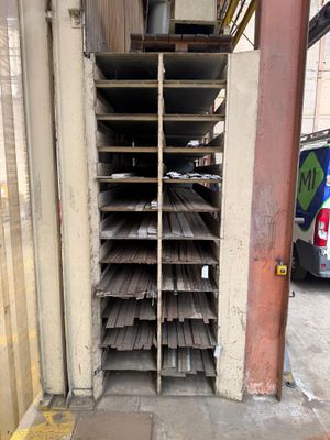 a rack of wooden planks on the side of a building