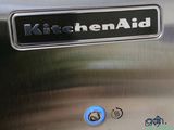 a close up of a kitchen aid sign on the side of a stainless steel refrigerator