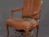 une vieille chaise en bois avec une assise rembourrée marron