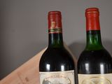 two bottles of wine sitting next to each other on a table