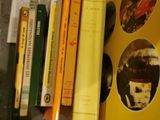 a lot of books on a table with a yellow cover
