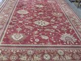 a large red rug on the floor in a room