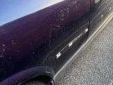 a purple car that is parked on the side of the road