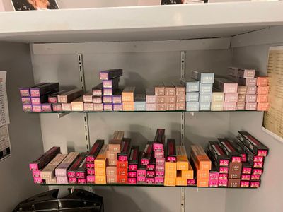 a lot of lipsticks on the shelves in the store