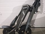 a scooter that is parked in front of a garage door