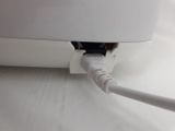 a close up view of a computer mouse connected to a power cord
