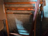 a pile of pipes and pipes in a room with concrete walls