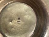 a silver plate with a small square in the middle