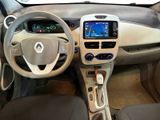the interior of a small car with a steering wheel and dashboard