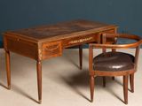 a desk with a chair next to it on the floor
