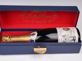 a bottle of champagne in a blue box on a table