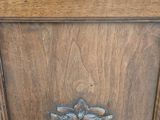 a wooden cabinet with a metal handle on top of it