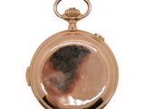 a gold pocket watch with a picture of a woman on it