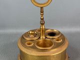 an image of a gold colored clock with a key on top of it