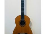 an acoustic guitar hanging on a wall in a room