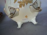 a white vase with a gold and white design on it