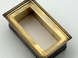 a picture of a small gold box on a white surface