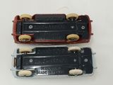 two toy trains sitting side by side on a white surface