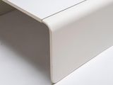 a close up of a white table with a drawer underneath it