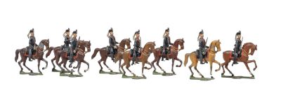 seven figurines of men riding horses on a white background