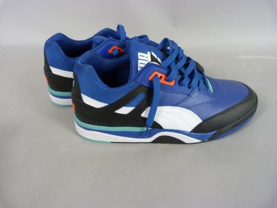 blue and black sneakers with orange accents on a white surface
