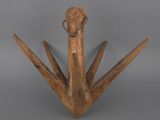 an image of a wooden sculpture of a bird on a gray background