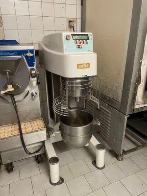 a machine that is sitting in a kitchen with a bowl on it