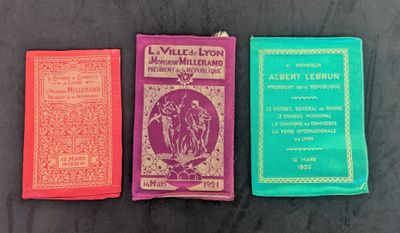 three books are lined up on a table with a black background