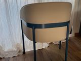a small table with a white top and blue legs