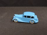 a blue toy car sitting on a brown surface