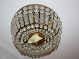 a chandelier hanging from the ceiling with a paper boat in it