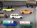 many toy cars and trucks in a display case