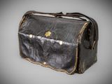 an old black leather bag with a gold star on it