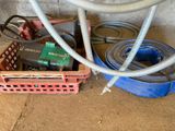 a basket full of hoses and a hose on the ground
