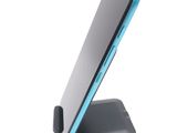 an image of a cell phone sitting on a stand on a white surface