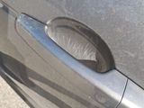 a close up of a car door handle with a sticker on it