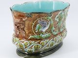 a blue and green bowl with a bird on it