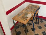 a table and two chairs in a room with red trim